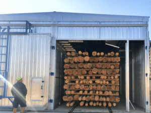 This image depicts a softwood dry kiln, a crucial piece of equipment in the timber industry. The kiln is designed to carefully reduce the moisture content of softwood, ensuring its quality and stability.